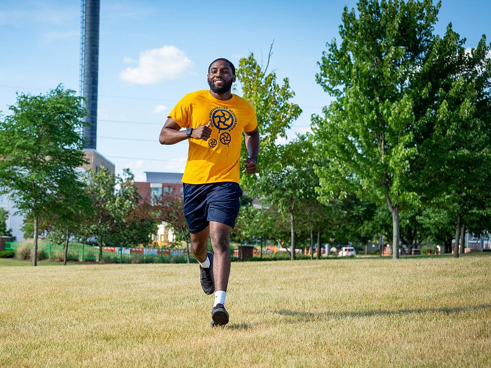 A student runs through Riverside Park that is across the street from the Powerhouse.