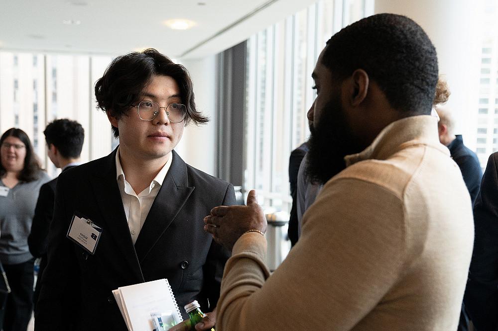 A student and alumni talk together at the 2024 Business Networking Summit.